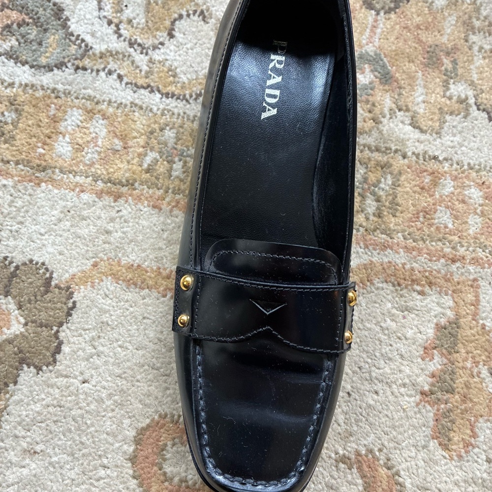 Prada Women's Elegant Black Loafers with Gold Accents
